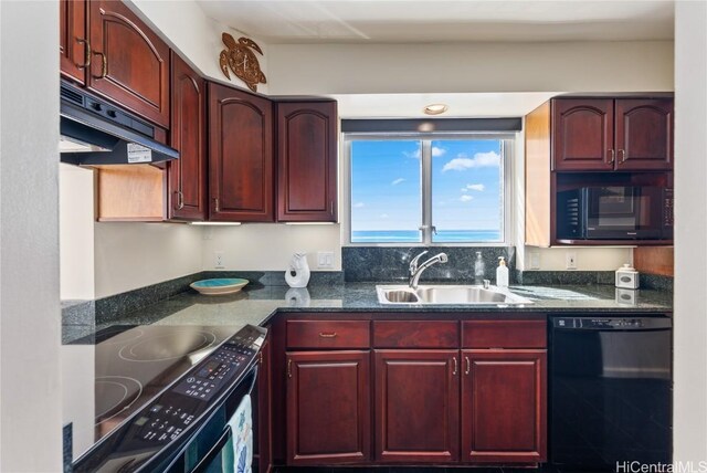 kitchen with sink, dark stone counters, and black appliances