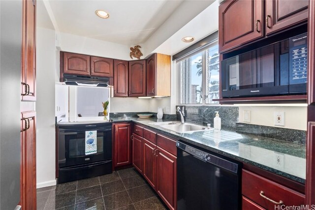 kitchen featuring exhaust hood, black appliances, sink, decorative backsplash, and dark stone countertops