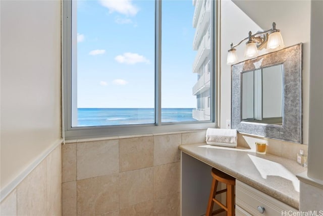 bathroom featuring a beach view and a water view