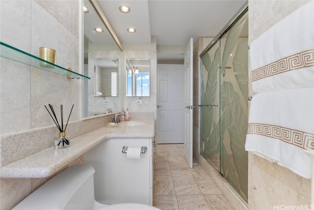 full bathroom with vanity, tile walls, recessed lighting, and a stall shower