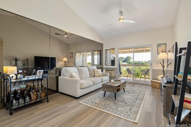 living room with high vaulted ceiling, a ceiling fan, and wood finished floors