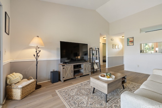 living room featuring hardwood / wood-style floors and lofted ceiling