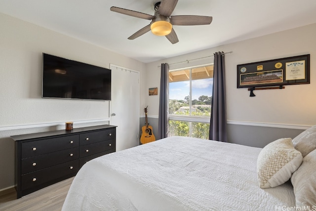 bedroom with light wood-type flooring and ceiling fan