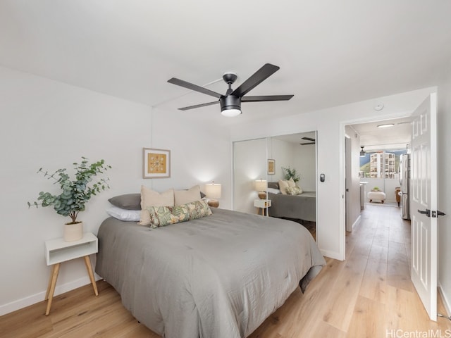 bedroom featuring a closet, light hardwood / wood-style flooring, and ceiling fan