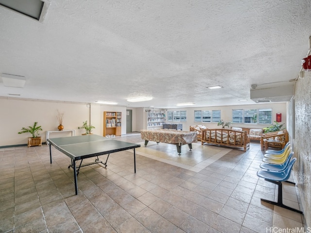 recreation room with light tile patterned floors, a textured ceiling, and pool table