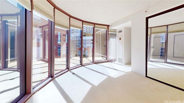 interior space with plenty of natural light and a textured ceiling