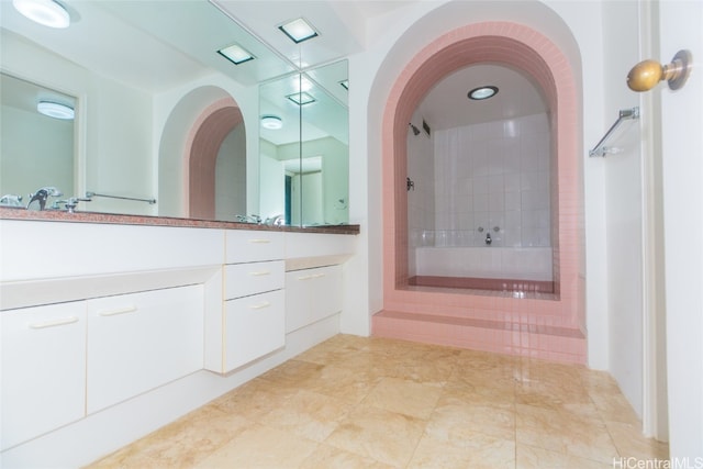 bathroom featuring tile patterned floors, vanity, and tiled shower