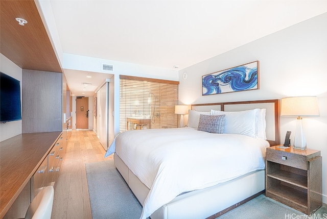 bedroom with light hardwood / wood-style flooring