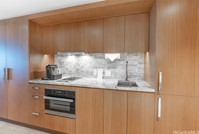 kitchen with backsplash, electric cooktop, oven, sink, and range hood