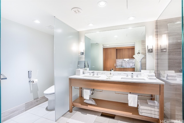 bathroom featuring tile patterned floors, vanity, toilet, and a shower with door