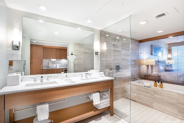 bathroom featuring tile patterned flooring, vanity, and shower with separate bathtub