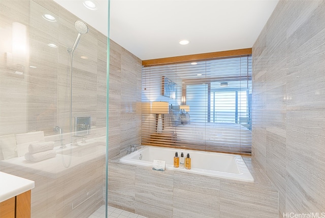 bathroom with plus walk in shower and tile walls