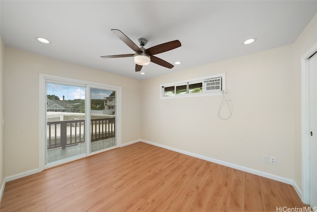 spare room with light wood-type flooring and ceiling fan