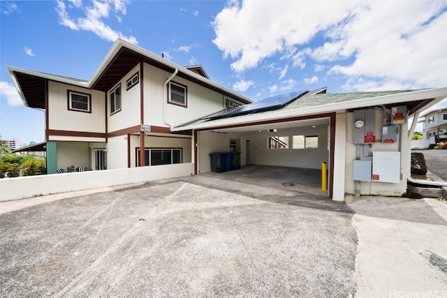 view of property exterior with a carport and solar panels