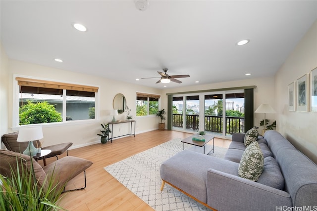 living room with ceiling fan and light wood-type flooring