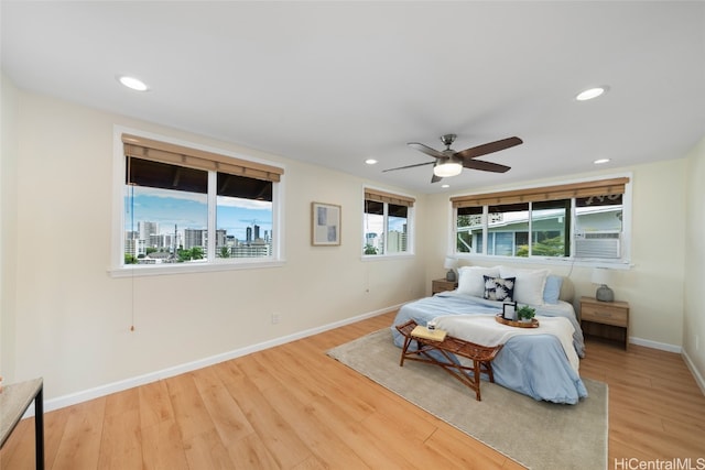 bedroom with light hardwood / wood-style flooring and ceiling fan