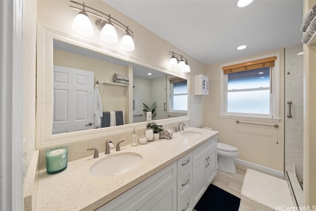 bathroom with toilet, vanity, and walk in shower