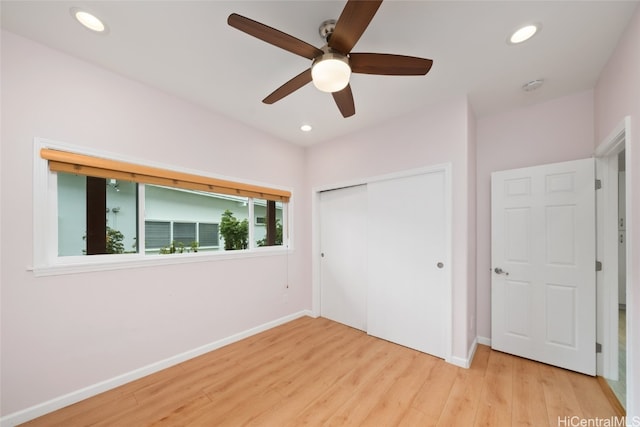 unfurnished bedroom featuring a closet, light hardwood / wood-style flooring, and ceiling fan