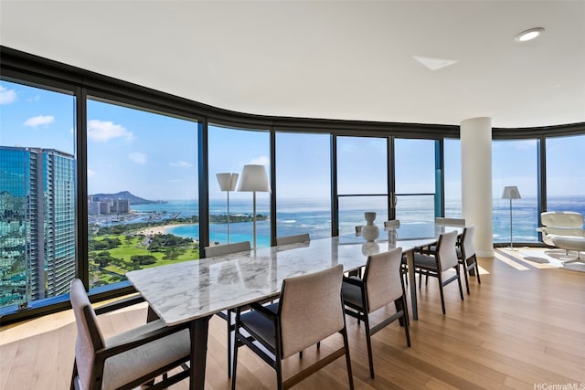 1108 Auahi St Unit 3000, Honolulu, HI 96814 - dining space featuring expansive windows, wood finished floors, and a water view