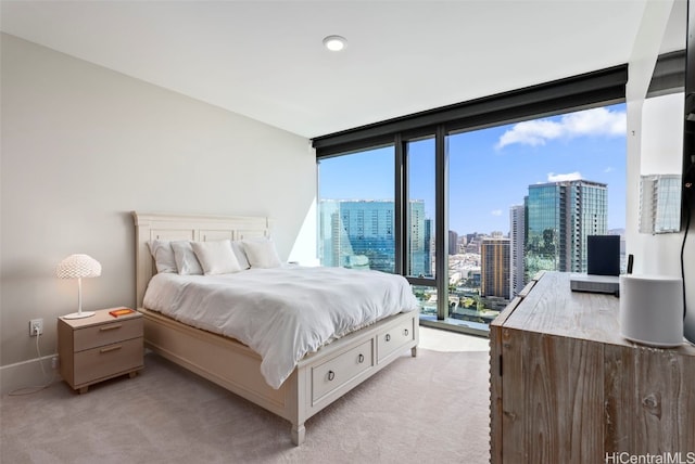 carpeted bedroom with access to exterior and a wall of windows