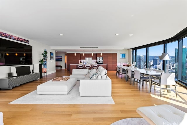 living room with hardwood / wood-style floors and floor to ceiling windows