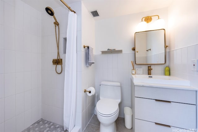 bathroom featuring tile patterned flooring, a shower with curtain, vanity, and tile walls