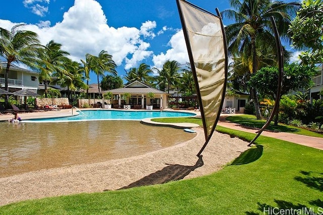 pool featuring a lawn and a patio