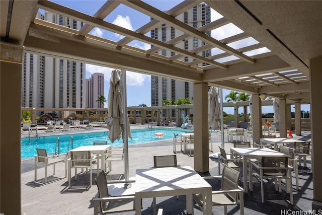 view of swimming pool featuring a pergola and a patio