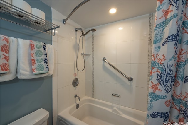 bathroom featuring shower / bath combination with curtain and toilet