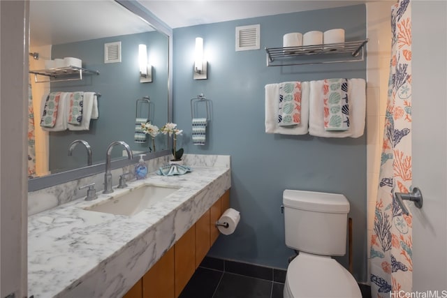 bathroom with tile patterned flooring, toilet, and sink