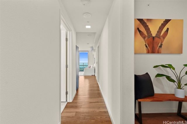 corridor with light hardwood / wood-style floors