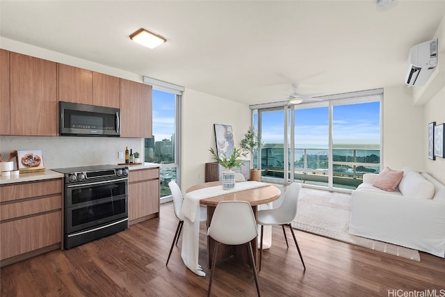 dining space featuring dark hardwood / wood-style floors, ceiling fan, a wall of windows, and an AC wall unit