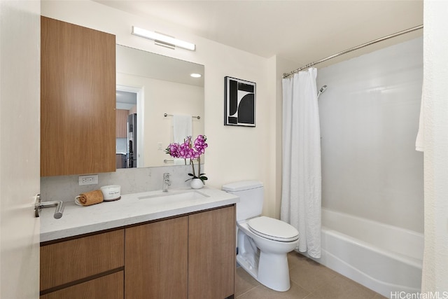 full bathroom featuring tile patterned flooring, shower / bath combination with curtain, vanity, and toilet