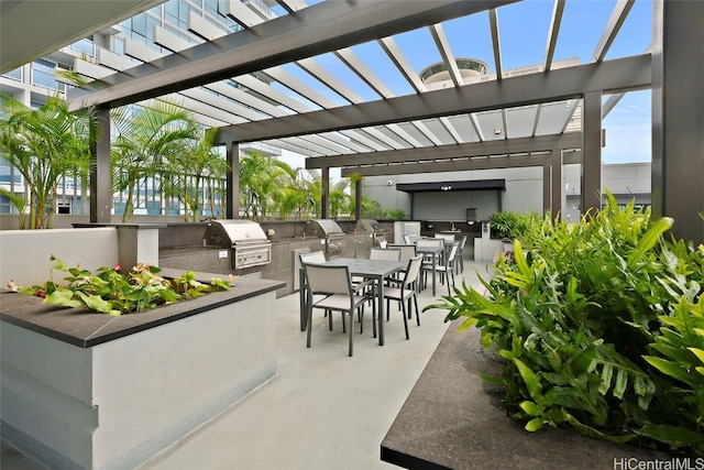 view of patio / terrace with an outdoor kitchen, a pergola, and a grill