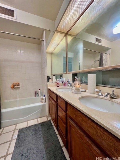 bathroom featuring shower / bath combo and vanity