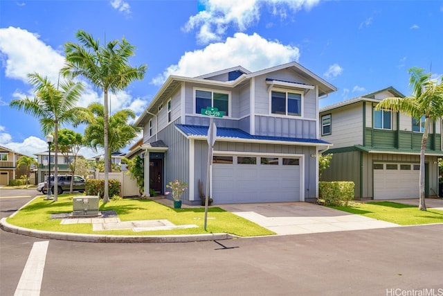 view of front of property with a front yard and a garage