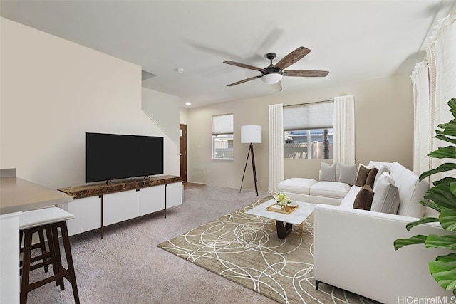 living room featuring carpet and ceiling fan