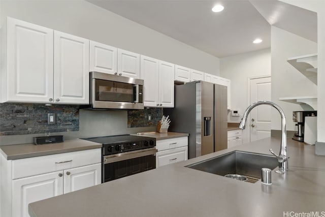 kitchen featuring decorative backsplash, white cabinetry, sink, and stainless steel appliances