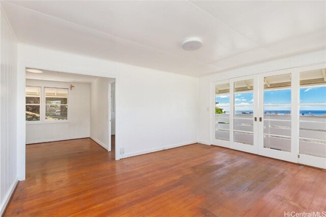 spare room featuring hardwood / wood-style floors and a water view