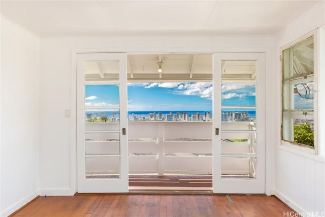 doorway to outside with a water view and wood-type flooring