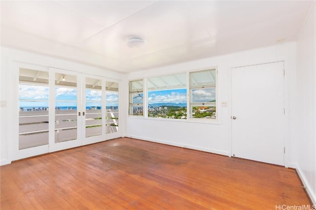 unfurnished sunroom featuring a water view