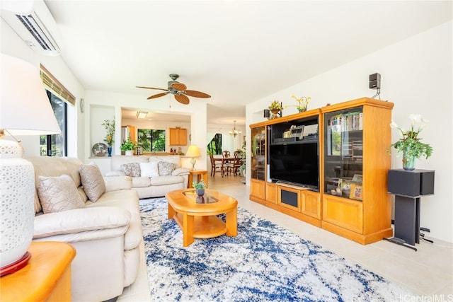 tiled living room featuring a wall mounted air conditioner and ceiling fan