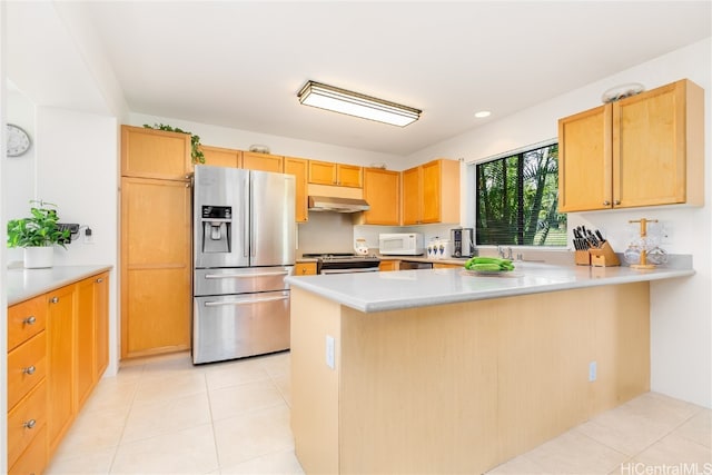 kitchen with light tile patterned floors, kitchen peninsula, and appliances with stainless steel finishes