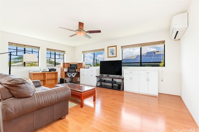 living room featuring ceiling fan, light hardwood / wood-style floors, and an AC wall unit