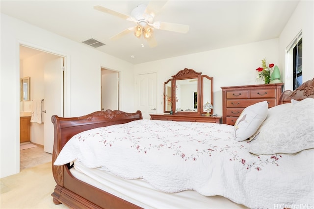 bedroom with light carpet, connected bathroom, and ceiling fan