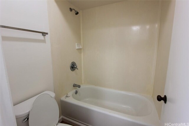 bathroom with bathing tub / shower combination and toilet