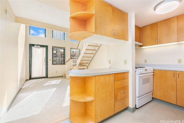 kitchen with electric range and kitchen peninsula