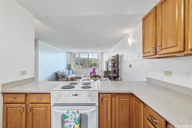 kitchen with tasteful backsplash, light stone counters, and white stove