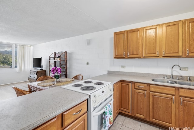 kitchen with light stone countertops, a textured ceiling, white electric stove, and sink