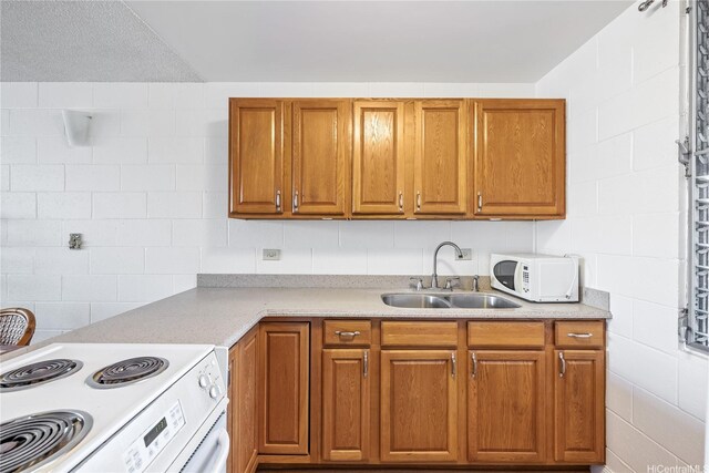 5122 Likini St Unit 302, Honolulu, HI 96818 - kitchen with white appliances, a sink, light countertops, and brown cabinetry